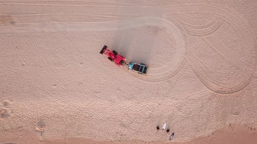 Aerial shot of beach tracktor cleaning manly beach