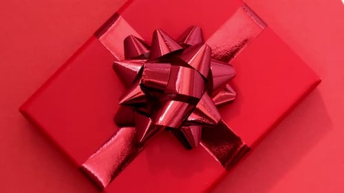 Red Gift Box Rotating Against Red Background