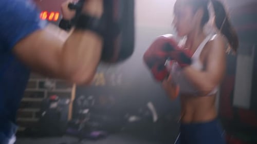 Sporty Coach Training Athlete woman Boxing exercise in Fitness Gym Healthy Lifestyle
