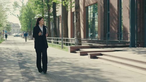 Happy Smiled Business Woman Wearing Formal Suit Going to the Business Centre Holding Her Laptop for