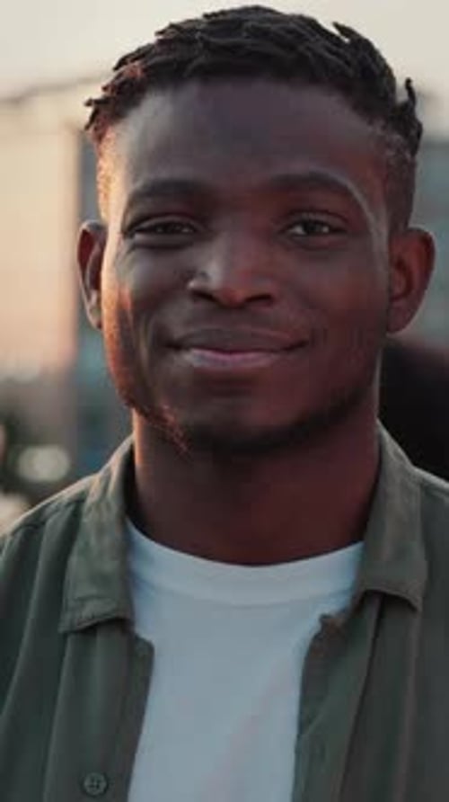 Young Man Smiling Outside During Golden Hour