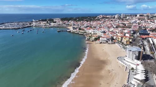 Panoramic Aerial View of Sunny Coastal Town Harbor and Beach