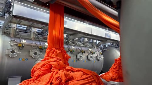 Textile Factory: Dyeing Process for Vibrant Orange Fabric