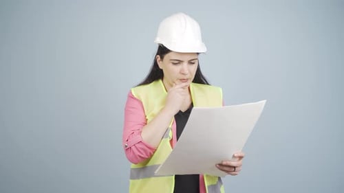 The engineer examines the project in her hands.