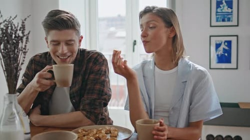 Couple Enjoying Snack and Coffee at Home