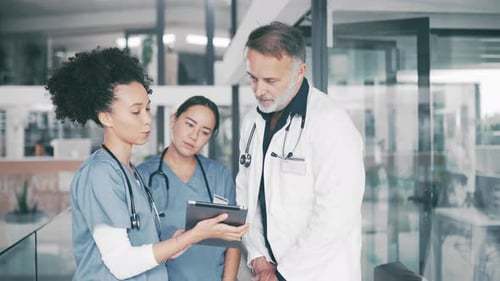 Senior man, doctor and tablet in meeting with interns, nurses or medical team at hospital