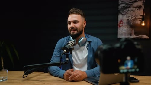 Man Recording Podcast in Studio with Microphone