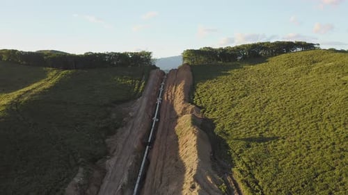 Laying the Main Gas Pipe in a Dug Trench Among the Mountains