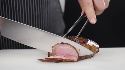 Slicing Roasted Meat on a Cutting Board