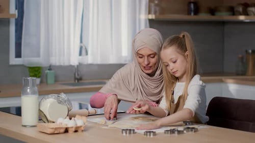 Mother and Daughter Making Cookies in Kitchen