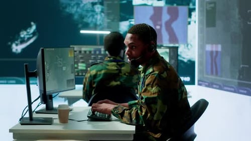 Soldiers in State of the Art Military Control Room Collaborate on Data Analysis
