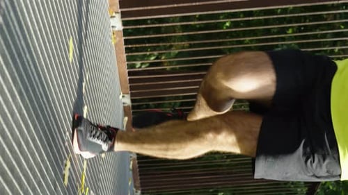 Vertical Screen Legs of Man Running on Bridge