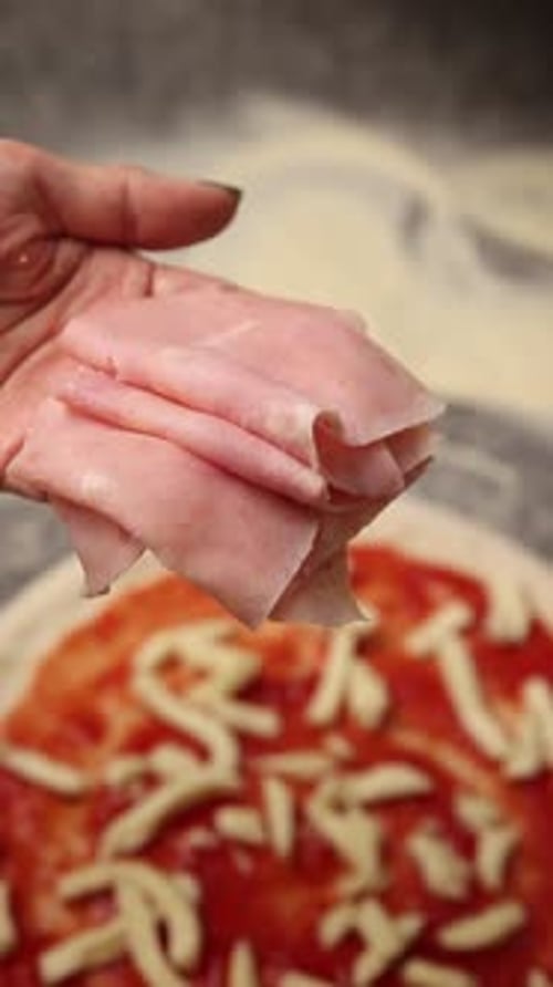 The chef makes delicious pizza in a professional kitchen.