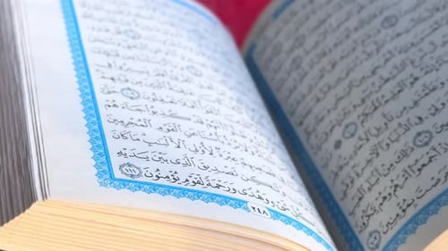 Close-Up of Quran Page with Arabic Calligraphy in 4K – Spiritual and Religious Footage.