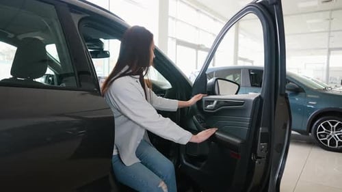 Female Client Customer Choosing New Car and Checks It Before Purchasing Right Hand Drive Car