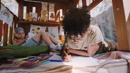 Kids Drawing Together in Homemade Treehouse Fort