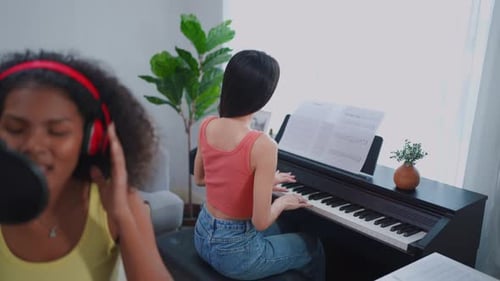 Diverse young stylish audio producer working in the music record studio.