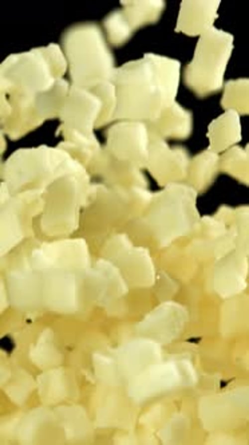 Mozzarella Cheese Flies Up and Falls Down on a Black Background Filmed on a Highspeed Camera at 1000