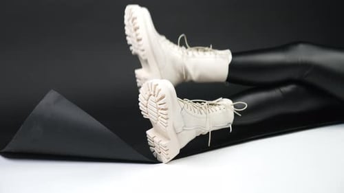 Laced Boots on a Figure in Shiny Leggings