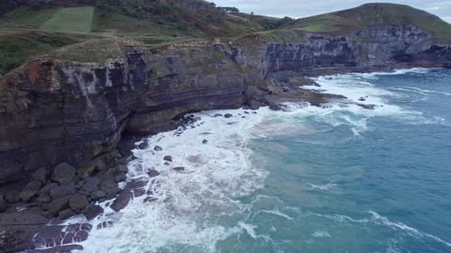 Drone capture the island of Isla, Cantabria and blue and emerald color Cantabrian sea from a great h