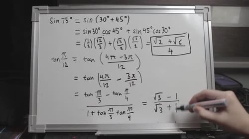 Hand writing solution to a mathematical equation on whiteboard. Mathematician writing trigonometric