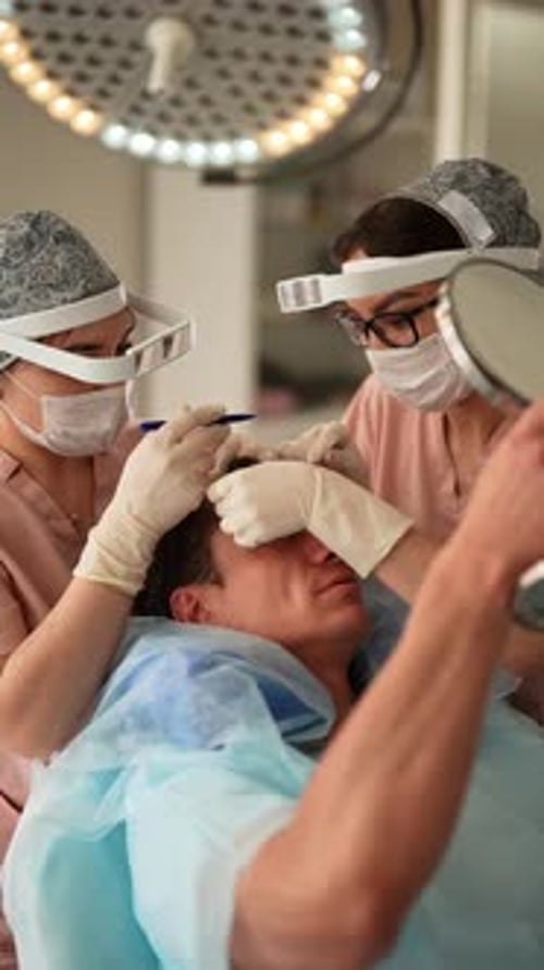 Medical Staff Performing Procedure in Clinical Setting