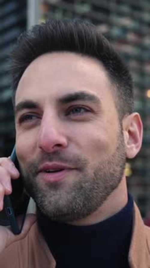 Man Chatting on Smartphone in Urban Setting