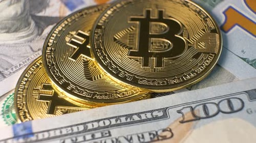 Close Up of Metal Shiny Bitcoin Crypto Currency Coins on US Dollar Bills