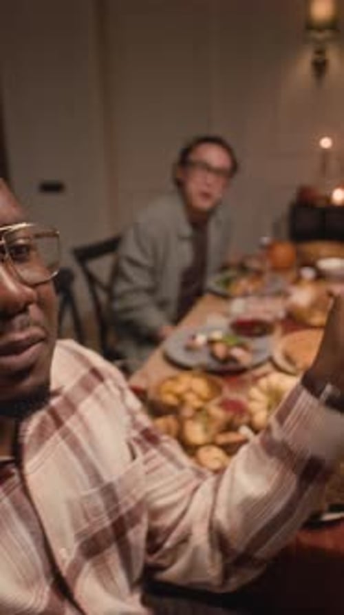 Friends Waving at Dinner Party in Home