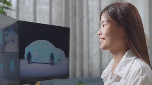 Close Up Side View Of Asian Female Automotive Designer Working On 3D Model Of Ev Car On Computer