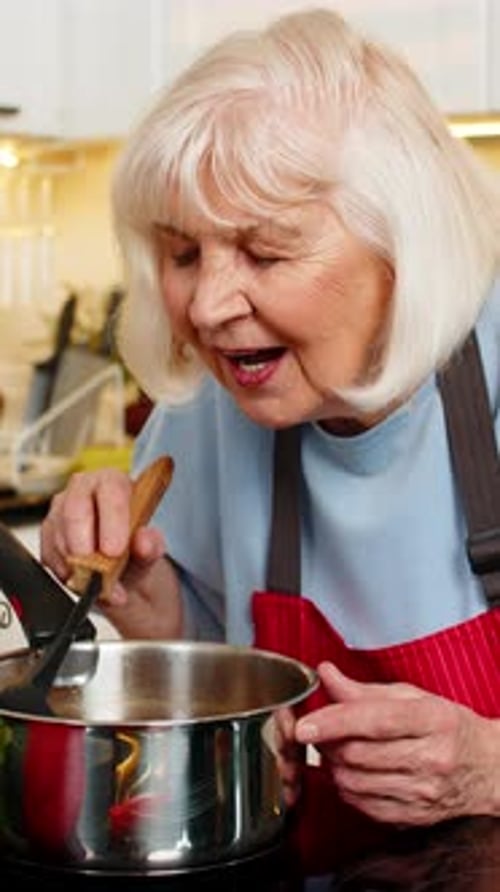 Senior Woman Cooking Food in Kitchen