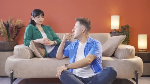 The couple is sad and unhappy at home.