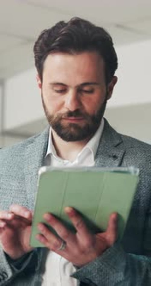 Creative, man and typing with tablet in office for research, proofreading and story submission