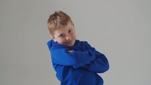 Portrait of Happy Smiling Boy in Blue Tshirt Attractive Kid in Studio Over Grey