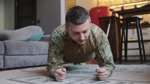Man Works Out Indoors in Plank Position