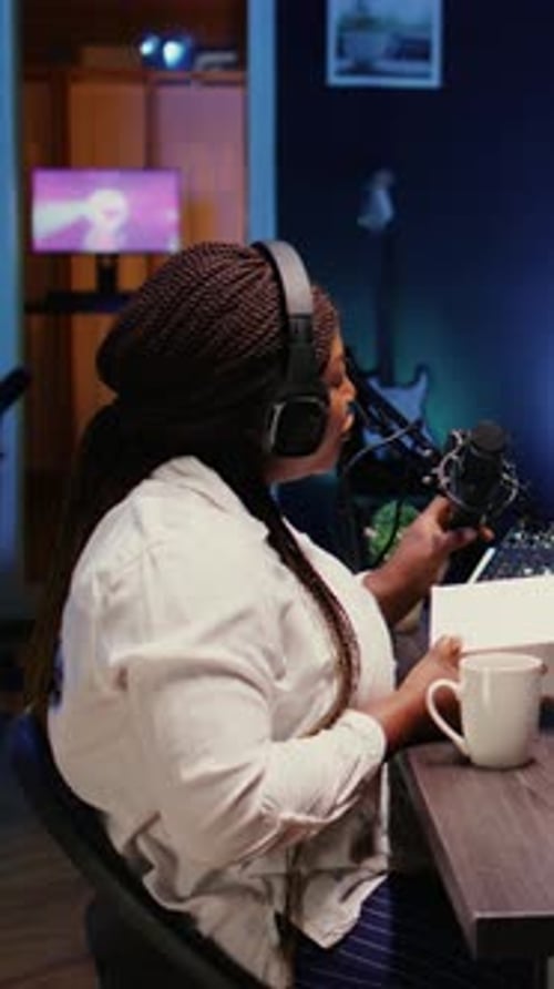 Podcast Host Recording with Audio Equipment in Studio