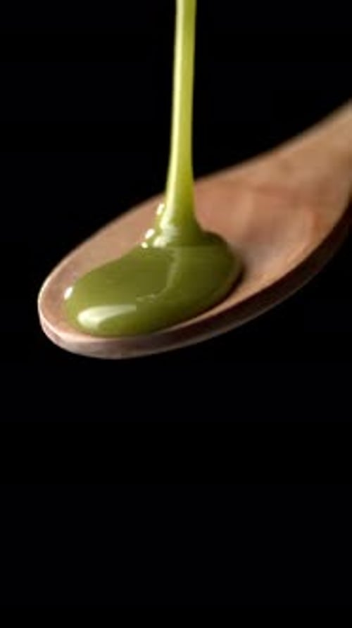 Pistachio Cream Dripping from Wooden Spoon – Vertical Video for Food Ads - CloseUp