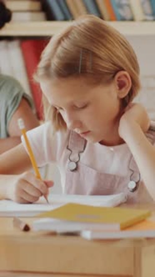 Focused Girl Doing Schoolwork at Desk