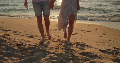 Young Loving Couple Enjoying Relaxing Sunset Walk on the Beach