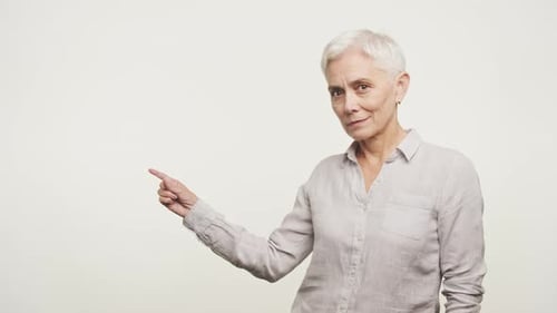 Mature Woman Point At Copy Space on White Background