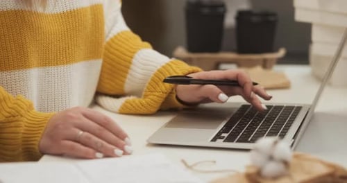 Close Up Entrepreneur Female Working on Laptop and Making a Note in Notepad Woman Growing Small
