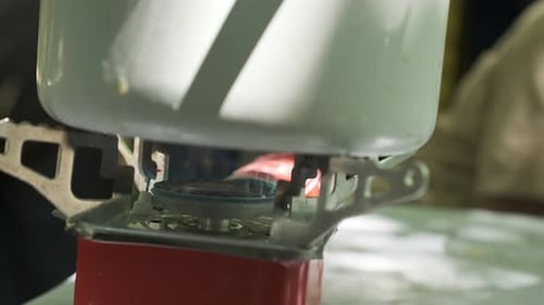 Tourist Gas Burner Close Up Camping Pot is on Portable Camping Gas Stove Water is Heated Camping