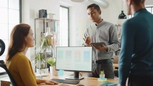 Team Discussing App Designs in Bright Modern Office