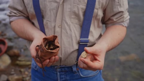 Unrecognizable Person of a Gold Digger in the Hands of a Full Bag of Gold Gold Rush