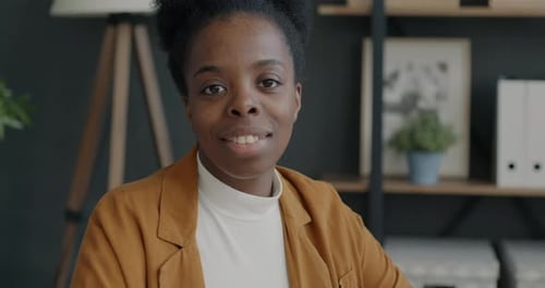 Portrait of Ambitious African American Businesswoman Smiling Indoors in Modern Office