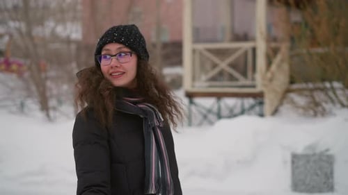 Woman Outdoors in Winter Wearing a Beanie and Scarf