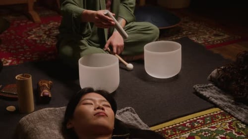 Chinese Woman Enjoying Sound Meditation with Singing Bowls