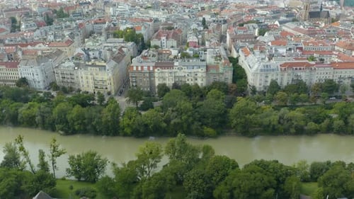 Danube river and Vienna Cityscape with ferry and business district. Bridges over the river, skyscrap