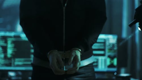 Hooded Man Apprehended in Dark Room by Police