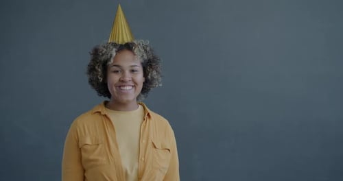 Woman Wearing Party Hat and Blowing Party Horn